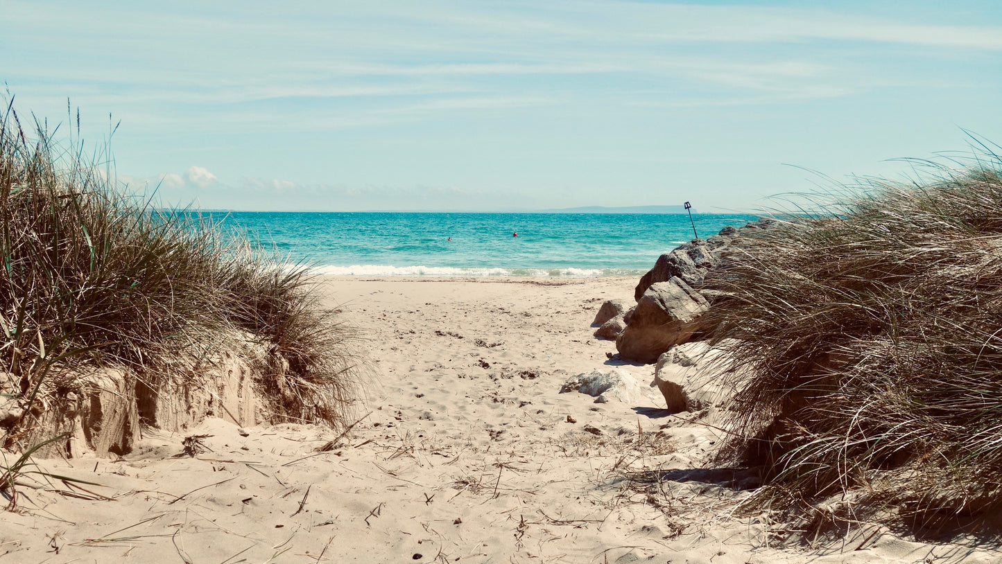 A view through the Dunes of Hensgistbury Head, across the sea to the Isle of Wight